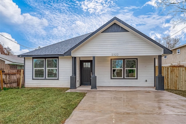 bungalow with a front yard and a porch