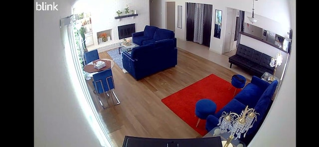 living room with hardwood / wood-style flooring and a fireplace