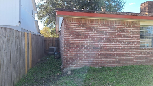 view of side of home with a lawn