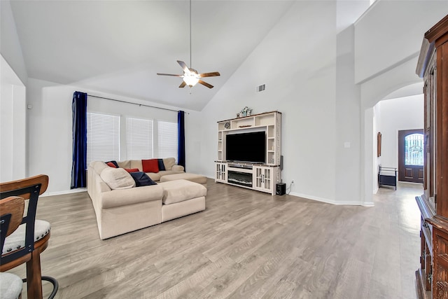 living room featuring high vaulted ceiling, light wood-type flooring, and ceiling fan