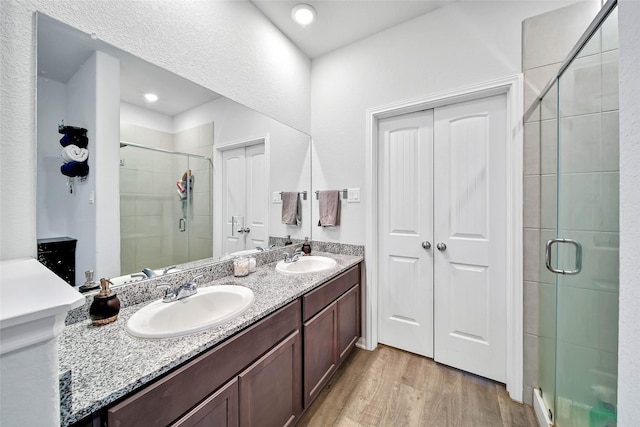 bathroom featuring vanity, a shower with door, and hardwood / wood-style floors