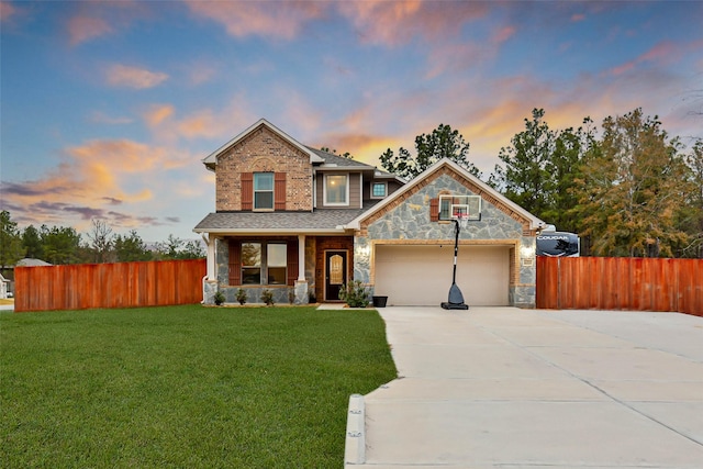 view of front of home featuring a garage, a lawn, and a porch