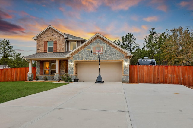 view of front of property with a garage, a lawn, and a porch