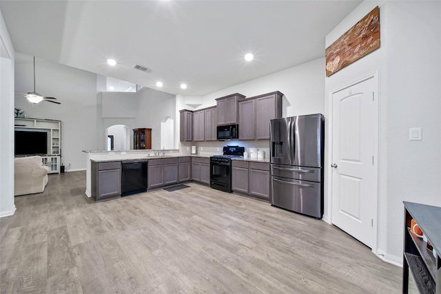 kitchen featuring black appliances, sink, kitchen peninsula, ceiling fan, and light hardwood / wood-style flooring