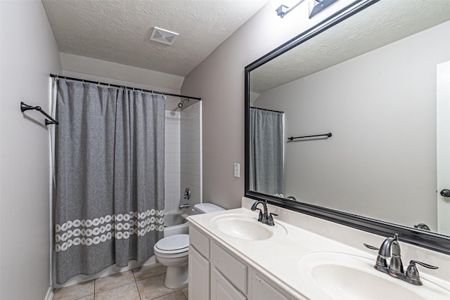 full bathroom with toilet, a textured ceiling, tile patterned floors, shower / bath combo, and vanity