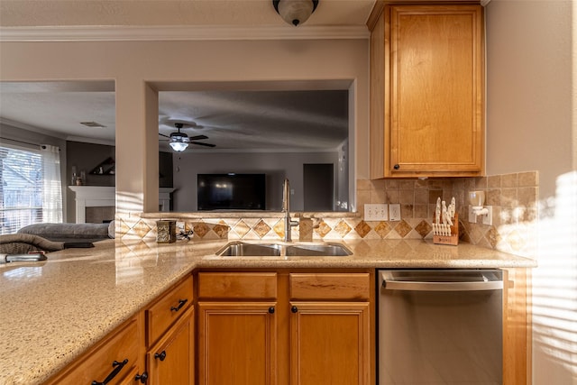 kitchen with ceiling fan, sink, ornamental molding, light stone counters, and stainless steel dishwasher