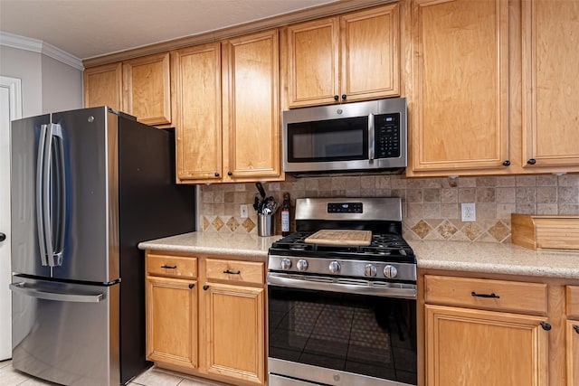 kitchen with stainless steel appliances, crown molding, tasteful backsplash, and light tile patterned flooring