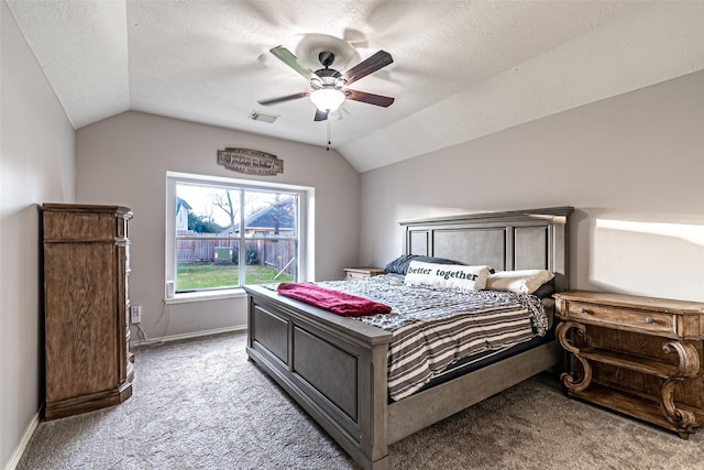 carpeted bedroom featuring ceiling fan, a textured ceiling, and lofted ceiling