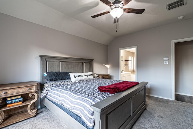 bedroom with carpet flooring, connected bathroom, vaulted ceiling, and ceiling fan