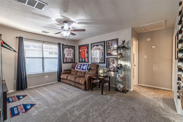 unfurnished living room featuring a textured ceiling, carpet floors, and ceiling fan