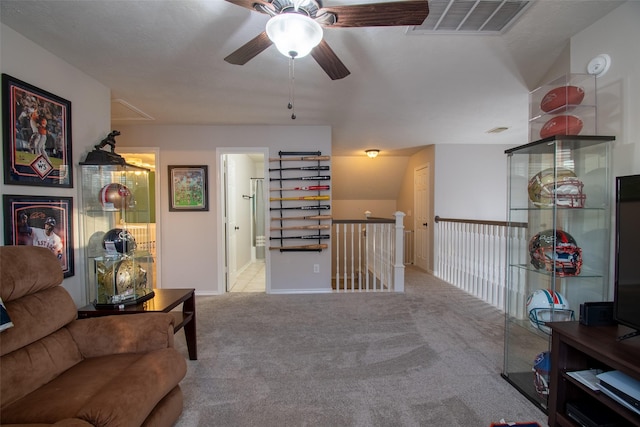 living area with ceiling fan and light carpet