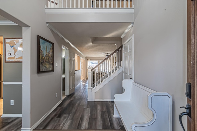 entryway featuring dark wood-type flooring and ornamental molding