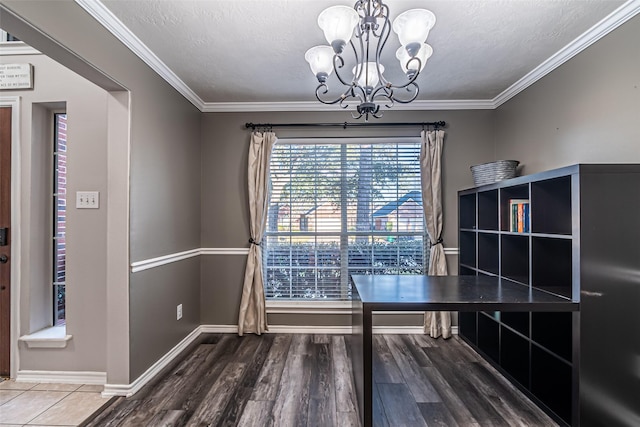 unfurnished office featuring an inviting chandelier, a textured ceiling, and crown molding