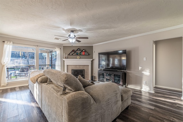 living room with crown molding, dark hardwood / wood-style floors, a fireplace, and a textured ceiling