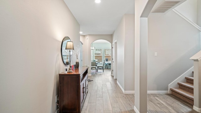 hallway with light hardwood / wood-style flooring