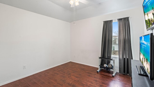 empty room featuring dark wood-type flooring, ceiling fan, lofted ceiling, and a wealth of natural light