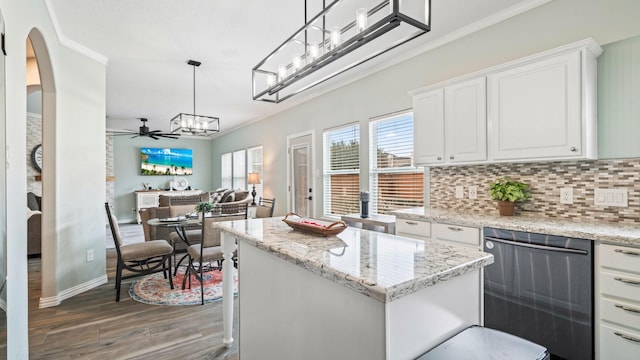 kitchen featuring dishwasher, white cabinetry, dark hardwood / wood-style floors, a center island, and decorative light fixtures