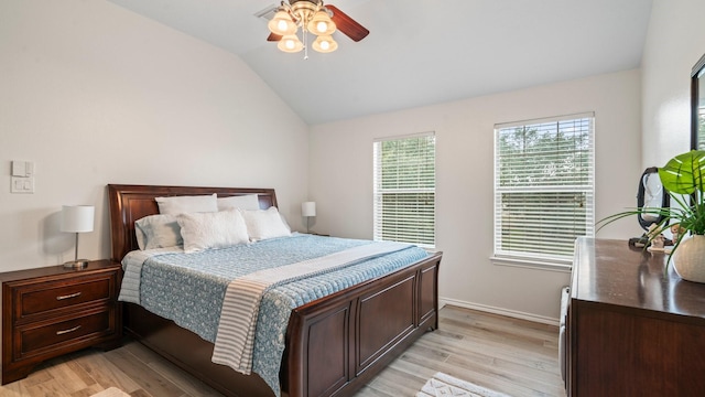 bedroom with ceiling fan, lofted ceiling, and light hardwood / wood-style floors