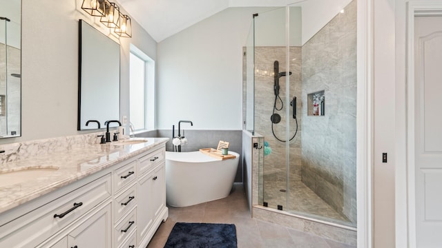 bathroom featuring vanity, vaulted ceiling, tile patterned floors, and separate shower and tub