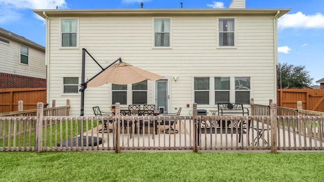 rear view of property featuring a yard