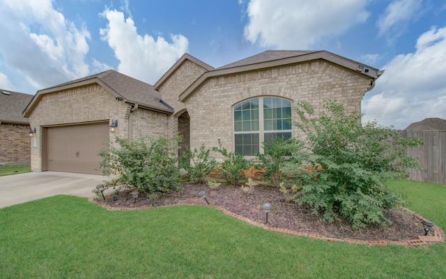 view of front of property featuring a front yard and a garage