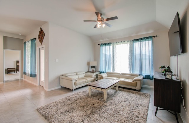 tiled living room featuring ceiling fan and lofted ceiling