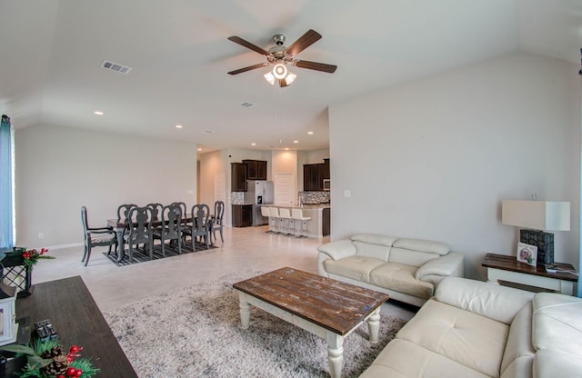 living room with ceiling fan and lofted ceiling