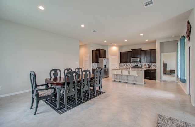 dining area featuring light tile patterned flooring