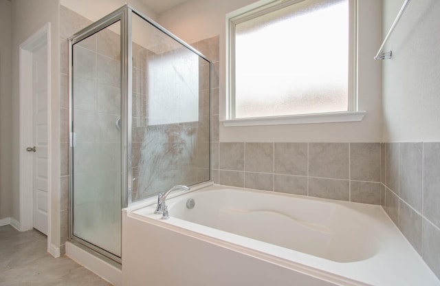 bathroom with tile patterned floors and independent shower and bath