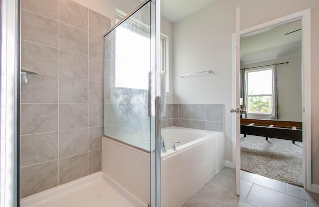 bathroom featuring tile patterned flooring and independent shower and bath