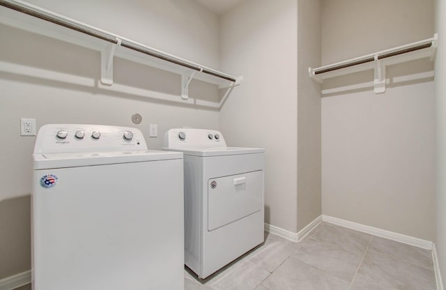 laundry area with light tile patterned floors and independent washer and dryer