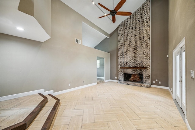 unfurnished living room featuring high vaulted ceiling, light parquet flooring, ceiling fan, and a brick fireplace