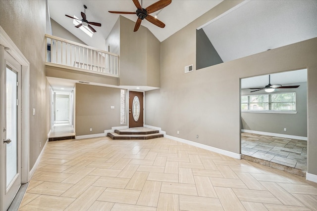 unfurnished living room with a high ceiling and light parquet floors