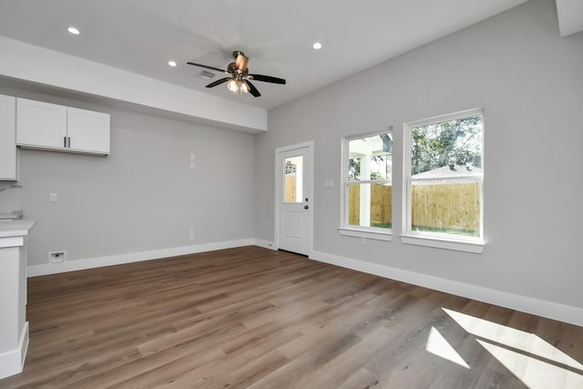 unfurnished living room with ceiling fan and light wood-type flooring