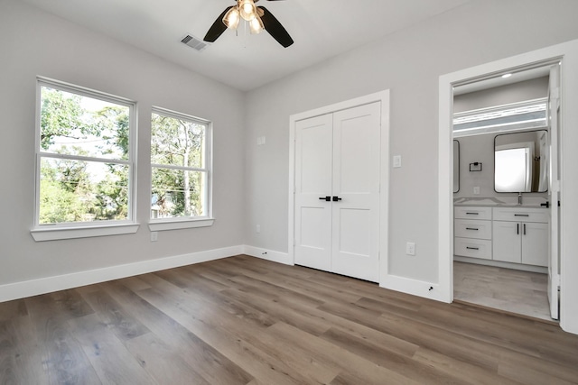 unfurnished bedroom featuring ceiling fan and wood-type flooring