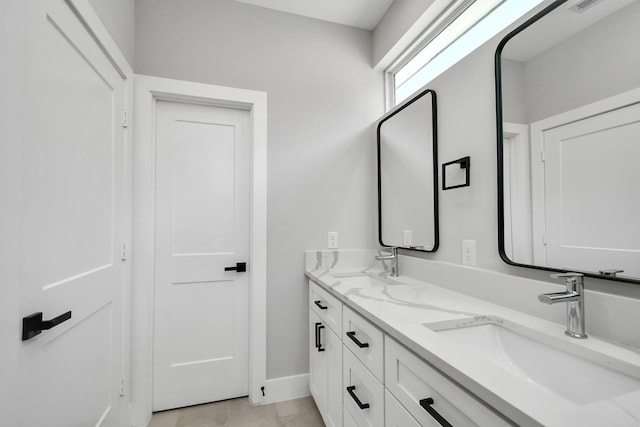 bathroom featuring tile patterned flooring and vanity