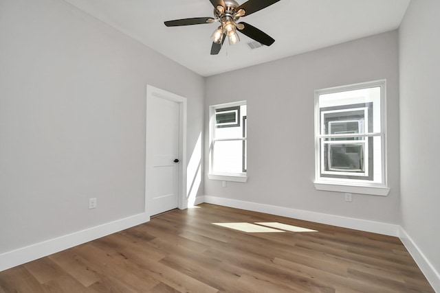 empty room featuring ceiling fan and hardwood / wood-style flooring