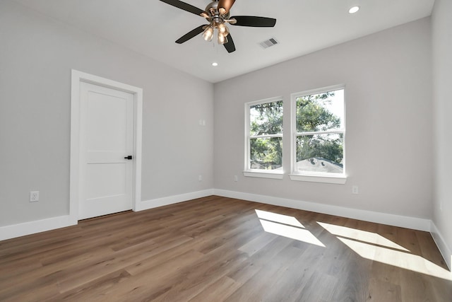 unfurnished room with ceiling fan and wood-type flooring