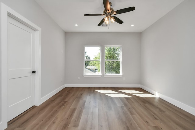 spare room with ceiling fan and light hardwood / wood-style flooring