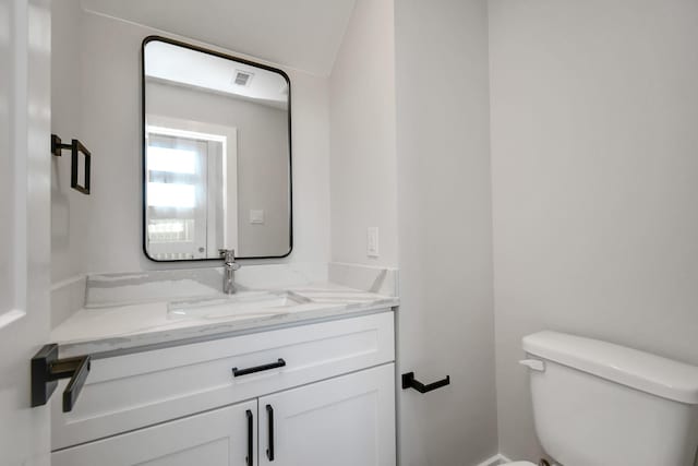 bathroom with toilet and vanity