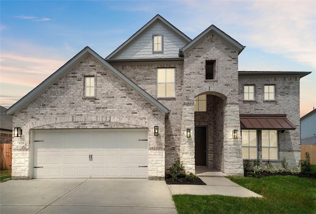 view of front of house featuring driveway and brick siding