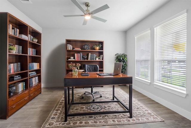 office featuring baseboards, a ceiling fan, and wood finished floors