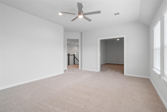 unfurnished bedroom featuring multiple windows, visible vents, baseboards, and light carpet