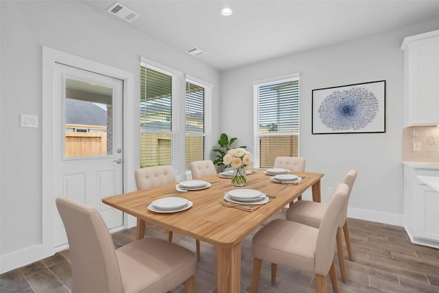 dining space with visible vents, baseboards, dark wood-type flooring, and recessed lighting