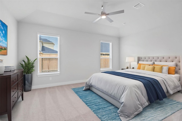 bedroom with light carpet, baseboards, visible vents, and multiple windows