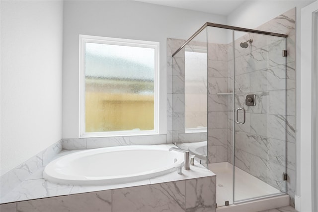 full bath featuring a garden tub and a shower stall
