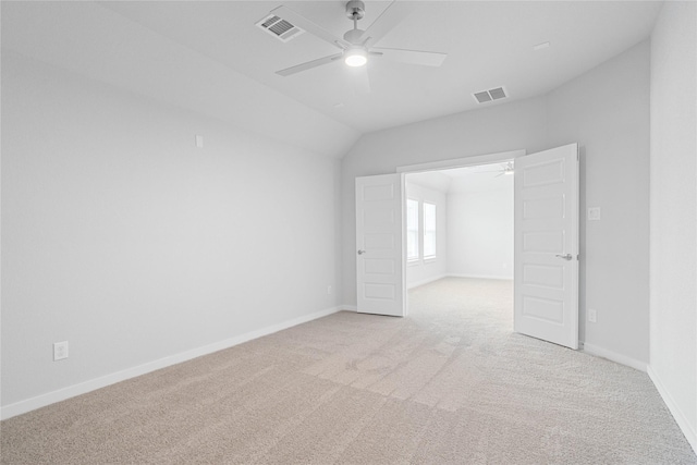 spare room with light colored carpet, visible vents, and ceiling fan