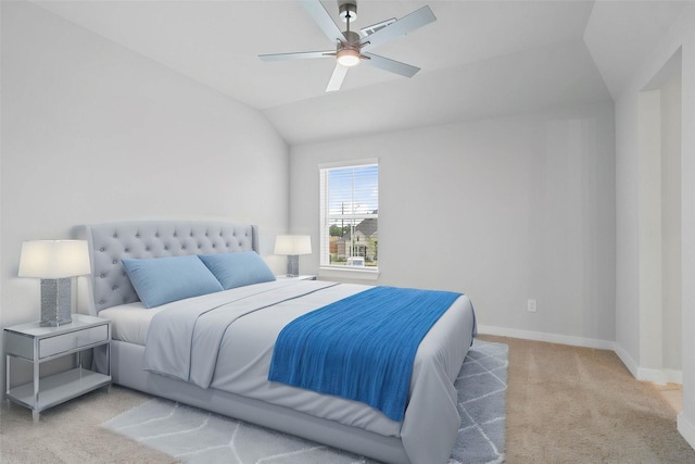 bedroom featuring baseboards, light carpet, ceiling fan, and vaulted ceiling
