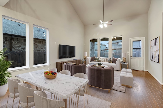 interior space with ceiling fan, hardwood / wood-style floors, and high vaulted ceiling