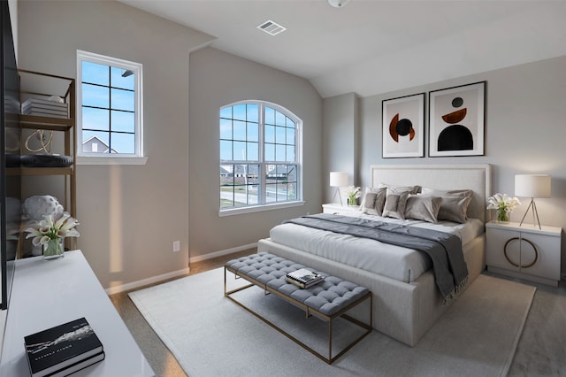 carpeted bedroom with vaulted ceiling